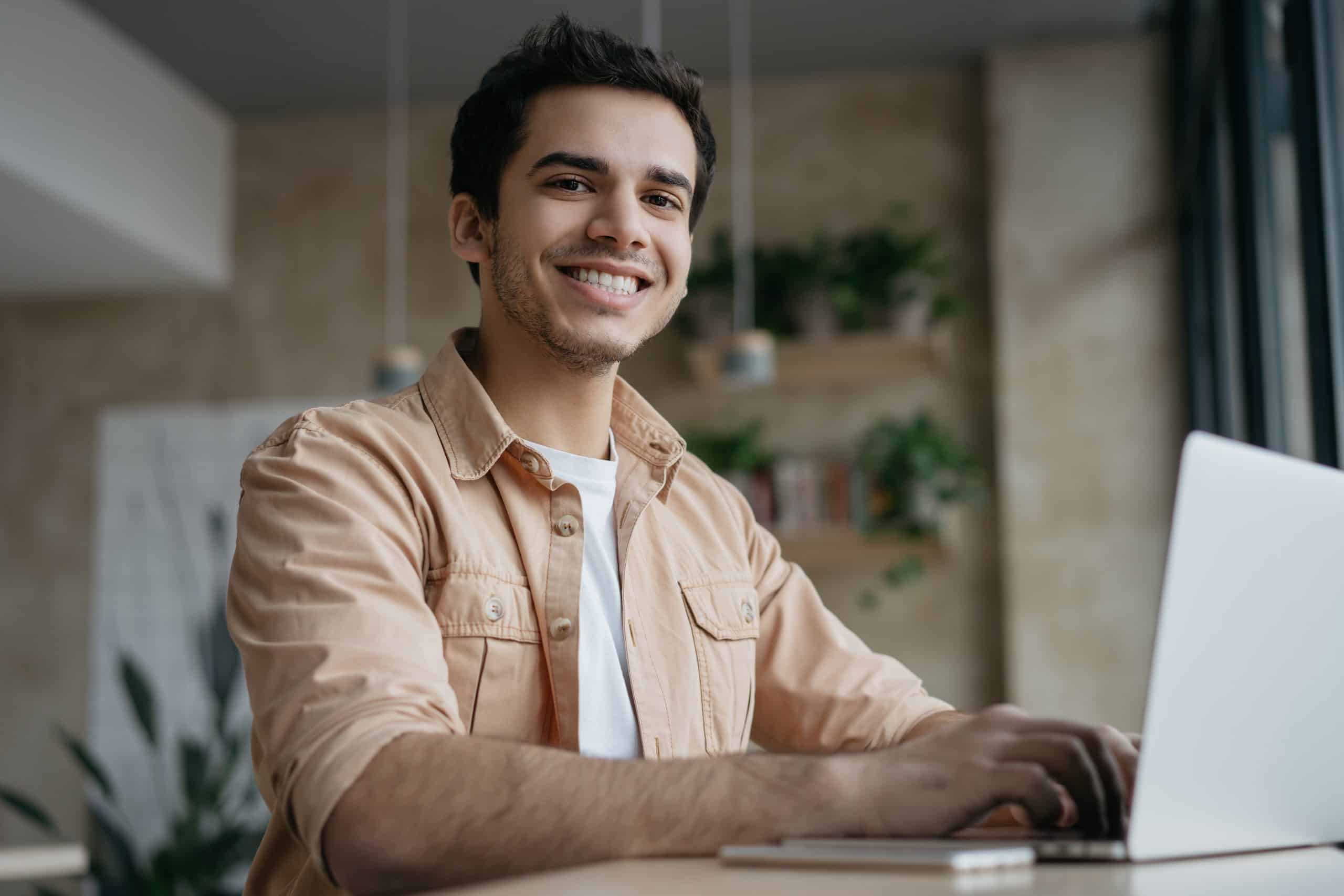 smiling freelancer copywriter using laptop working from home scaled Smile Dentist Toronto